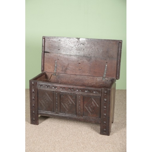 826 - AN OAK COFFER

the hinged lid opening to a vacant interior, the front carved with lozenge panels and... 