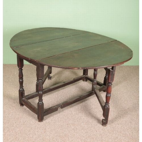 827 - A WILLIAM AND MARY OAK GATELEG TABLE

the oval top over a single frieze drawer, on turned legs joine... 