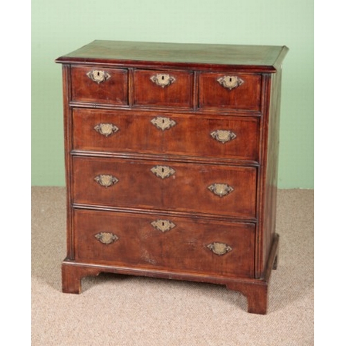 842 - A WALNUT CHEST OF DRAWERS

early 18th century, the crossbanded top over three short and three long d... 