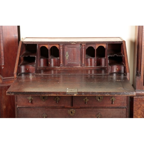 856 - AN OAK BUREAU

early 18th century, the fall front opening to an interior fitted with small drawers a... 