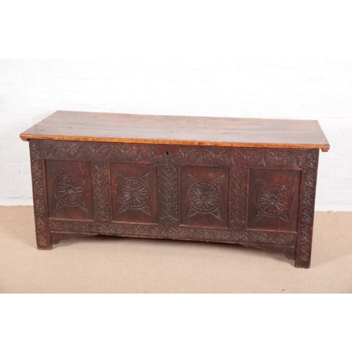 867 - A PANELLED OAK COFFER

early 18th century, the four panel front with rounded and lunette carving, st... 