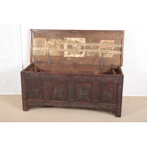 867 - A PANELLED OAK COFFER

early 18th century, the four panel front with rounded and lunette carving, st... 