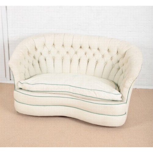 875 - AN EDWARDIAN KIDNEY-SHAPED TWO SEAT SETTEE

upholstered in cream floral repeat cloth with green pipi... 