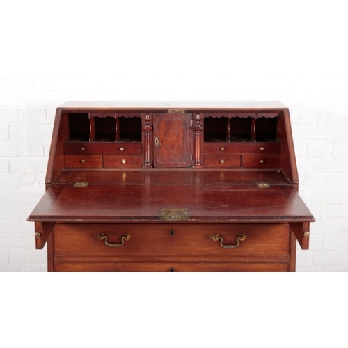 890 - A GEORGE III MAHOGANY BUREAU

the fall front enclosing a fitted interior of central cupboard, six sm... 