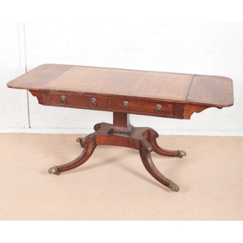 916 - A REGENCY ROSEWOOD SOFA TABLE

inlaid with twin brass bandings, the drop-leaf top with rounded corne... 