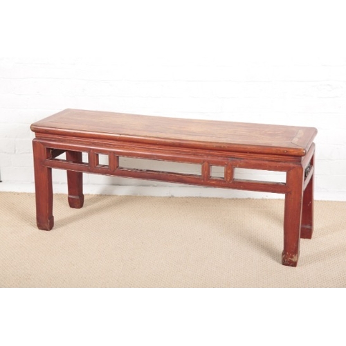 927 - A CHINESE RED PAINTED ELM LOW RECTANGULAR TABLE

early 20th century, with flush panelled top and pie... 