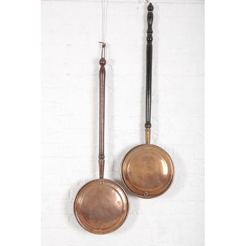 930 - A VICTORIAN COPPER WARMING PAN

with turned mahogany handle, 94cm long; and another copper warming p... 