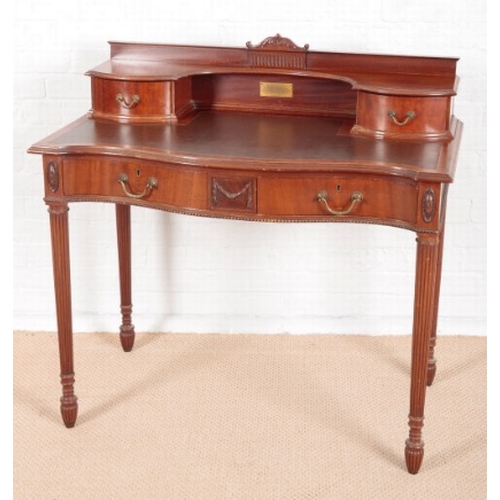 931 - AN EDWARDIAN MAHOGANY LADY'S SERPENTINE FRONTED DESK

by James Shoolbred & Co, London, of 'Carlton H... 