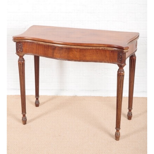 936 - A GEORGE III REVIVAL MAHOGANY SERPENTINE FRONTED TEA TABLE

on turned reeded legs, 74cm high x 89cm ... 