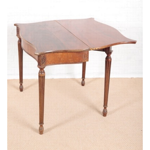 936 - A GEORGE III REVIVAL MAHOGANY SERPENTINE FRONTED TEA TABLE

on turned reeded legs, 74cm high x 89cm ... 