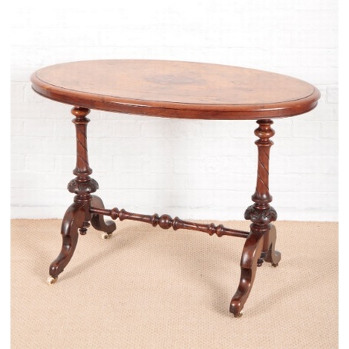 939 - A VICTORIAN OVAL WALNUT CENTRE TABLE

with satinwood inlay, on turned supports with cabriole legs an... 