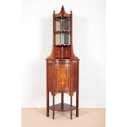 940 - AN EDWARDIAN MAHOGANY CORNER STAND

with a mirrored top and satinwood inlaid cupboard, on square cha... 