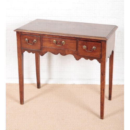 942 - A GEORGE III MAHOGANY LOW BOY

with three single drawers, on square chamfered legs with brass castor... 