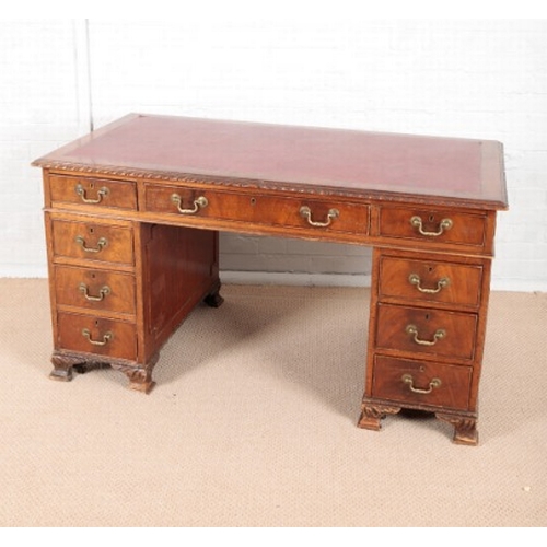 947 - AN EDWARDIAN MAHOGANY PEDESTAL DESK

with leatherette top above nine single drawers with hooped bras... 