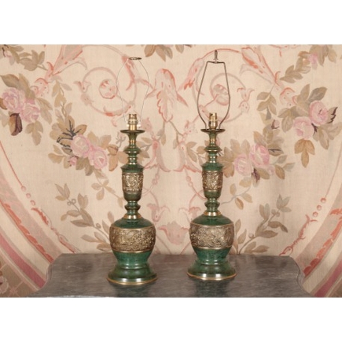 95 - A PAIR OF PATINATED METAL TABLE LAMPS

20th century, decorated with relief cast bands of phoenix amo... 