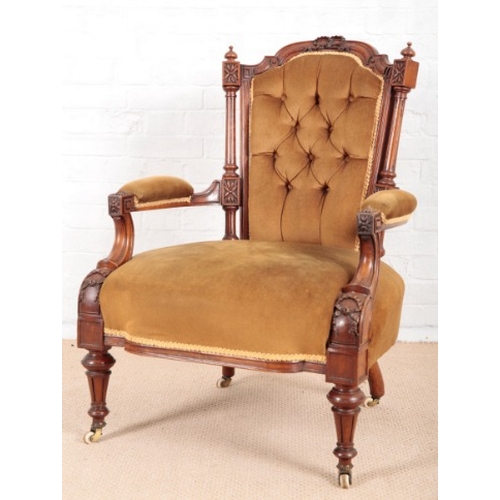 961 - A VICTORIAN WALNUT OPEN ARMCHAIR

with carved ribbon and floral ornament throughout, the shaped cres... 