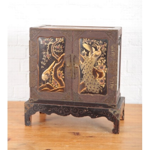 968 - A JAPANESE METAL BOUND LACQUERED TABLE CABINET

Meiji period, decorated throughout in raised gilding... 