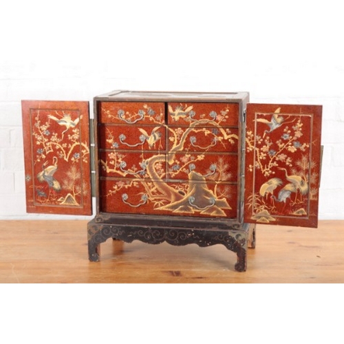 968 - A JAPANESE METAL BOUND LACQUERED TABLE CABINET

Meiji period, decorated throughout in raised gilding... 