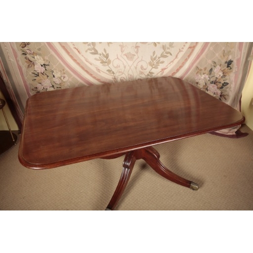 98 - A REGENCY MAHOGANY DINING TABLE

the rectangular tilt-top on a baluster-turned stem to downswept mou... 