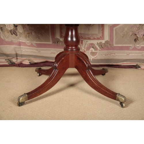 98 - A REGENCY MAHOGANY DINING TABLE

the rectangular tilt-top on a baluster-turned stem to downswept mou... 