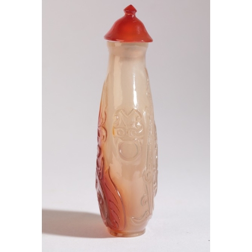 102 - A CHINESE AGATE SNUFF BOTTLE

19th century, both sides finely carved with archaic dragons, mask and ... 