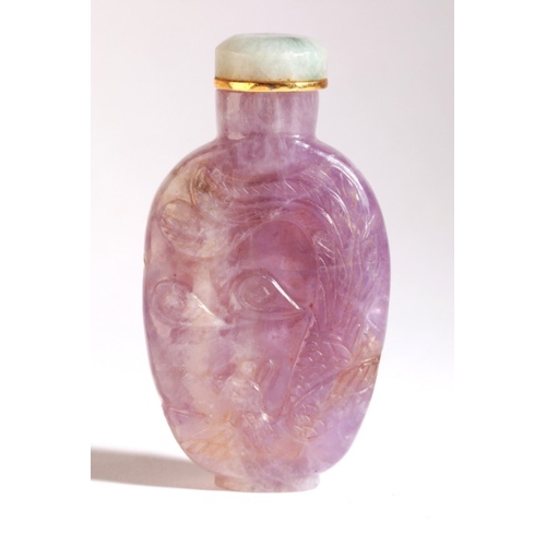 106 - A CHINESE AMETHYST SNUFF BOTTLE

19th century, with a carved dragon to the front and phoenix to the ... 