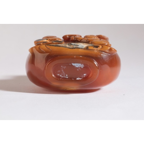 110 - A CHINESE AGATE SNUFF BOTTLE

19th century, the ochre skin to the front carved with two boys seated ... 