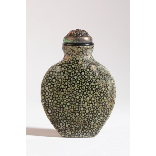 115 - A CHINESE SHAGREEN SNUFF BOTTLE

19th century, the shield shaped bottle with sharkskin coating, 5.5c... 