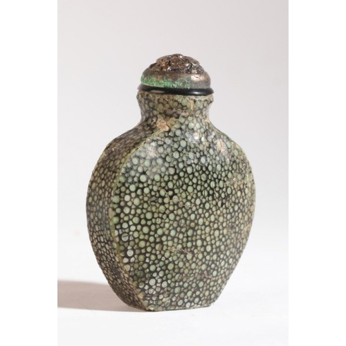 115 - A CHINESE SHAGREEN SNUFF BOTTLE

19th century, the shield shaped bottle with sharkskin coating, 5.5c... 