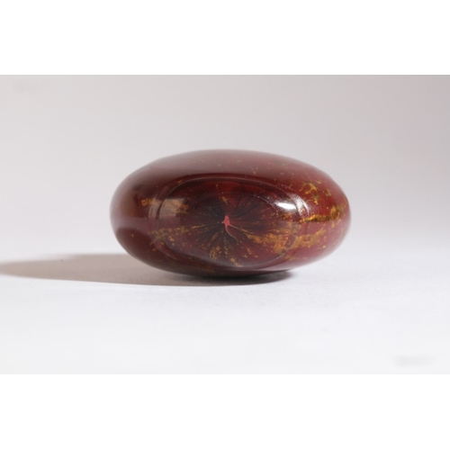 129 - A CHINESE RED AVENTURINE GLASS SNUFF BOTTLE

probably 19th century, of bulbous form, 5.5cm high 

Th... 