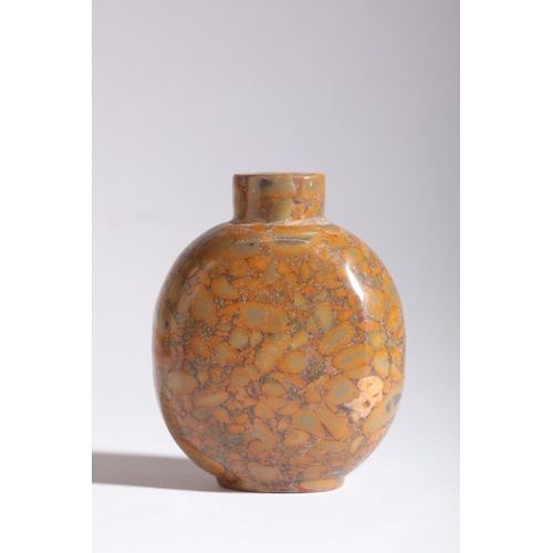 130 - A CHINESE 'PUDDINGSTONE' SNUFF BOTTLE

likely 18th/19th century, of circular form with carved recess... 