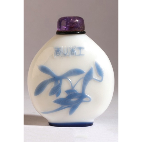 142 - A CHINESE GLASS SNUFF BOTTLE

18th/19th century, the opaque body with light blue overlay depicting a... 