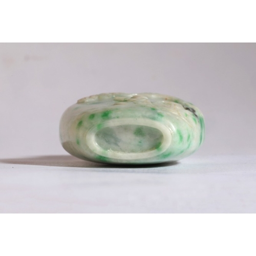 15 - A CHINESE JADEITE SNUFF BOTTLE

19th century, carved to one side with a figure in a boat beneath a p... 