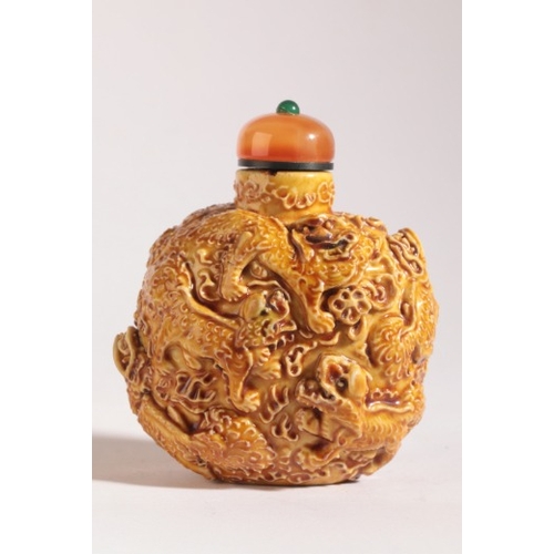 154 - A CHINESE PORCELAIN SNUFF BOTTLE

19th century, the yellow-glazed body moulded in high relief with n... 