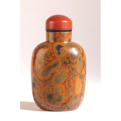 174 - A CHINESE 'PUDDING STONE' SNUFF BOTTLE

likely 18th/19th century, of rounded rectangular form, the o... 