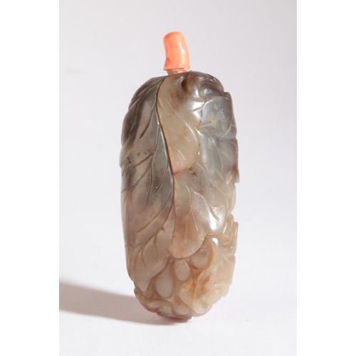 180 - A CHINESE JADE SNUFF BOTTLE

probably 19th century, of pebble form, carved with leaves and berries t... 