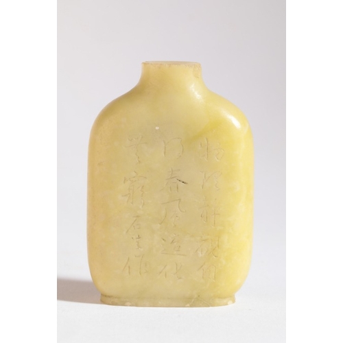 182 - A CHINESE JADE SNUFF BOTTLE

probably 19th century, carved to one side with an inscription, the othe... 