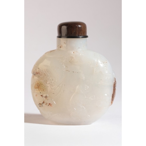 2 - A CHINESE JADE SNUFF BOTTLE

19th century, the white and russet stone carved with an ox and rider to... 