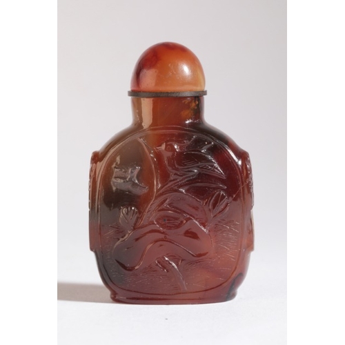 31 - A CHINESE AGATE SNUFF BOTTLE

19th century, of square form with a carved coiled dragon to one side a... 