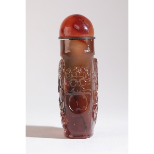 31 - A CHINESE AGATE SNUFF BOTTLE

19th century, of square form with a carved coiled dragon to one side a... 