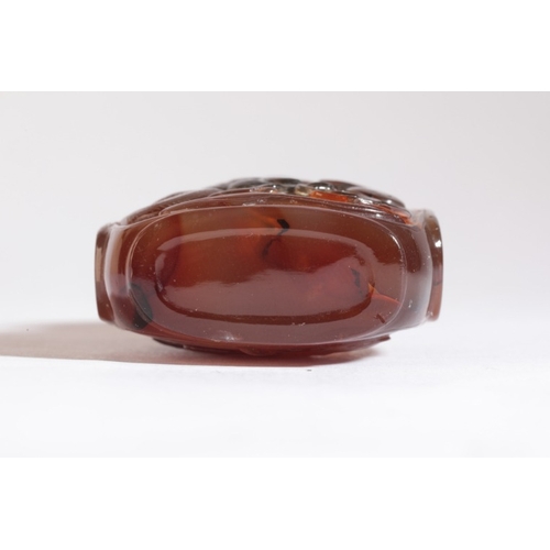 31 - A CHINESE AGATE SNUFF BOTTLE

19th century, of square form with a carved coiled dragon to one side a... 