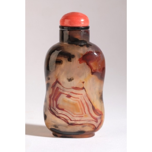 39 - A CHINESE AGATE SNUFF BOTTLE

18th/19th century, with several red and brown/black inclusions, some i... 