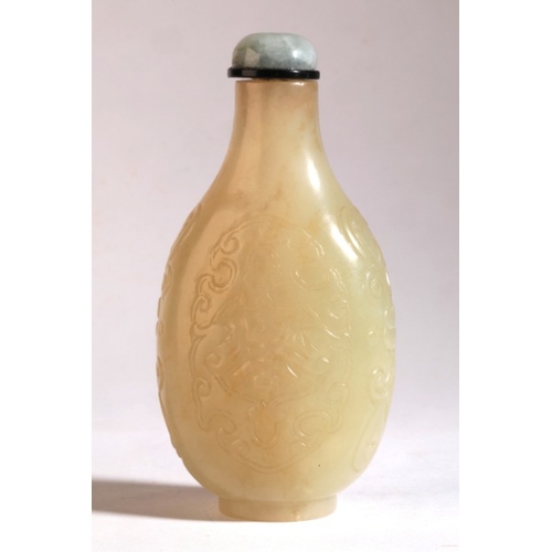 4 - A CHINESE PALE GREEN JADE SNUFF BOTTLE

Qing Dynasty, carved and incised with lotuses and 'shou' sym... 