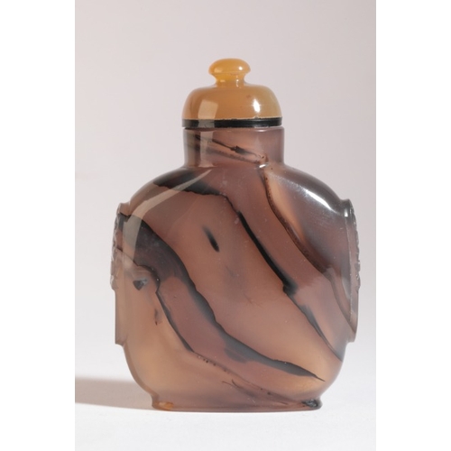 43 - A CHINESE AGATE SNUFF BOTTLE

18th/19th century, with carved mask and ring handles to each side, 8cm... 