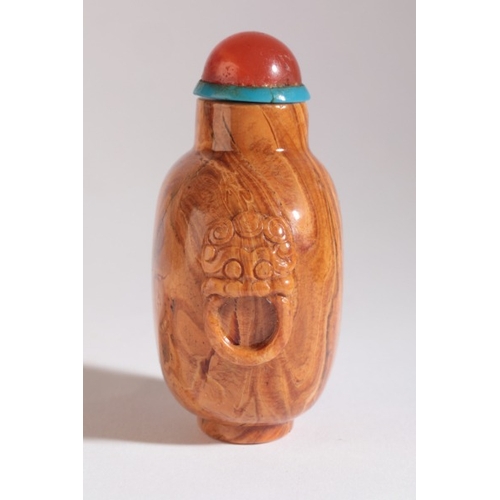 46 - A CHINESE ROOT AMBER SNUFF BOTTLE

18th/19th century, carved to each shoulder with lion mask and sus... 