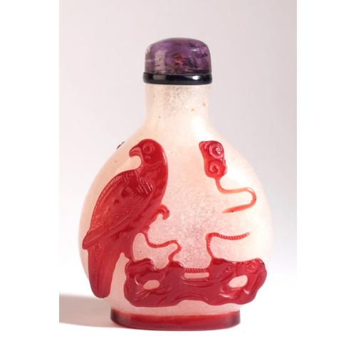 47 - A CHINESE OVERLAY GLASS SNUFF BOTTLE

18th/19th century, the pear shaped body of frosted glass with ... 