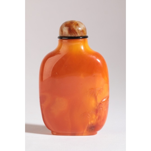 49 - A CHINESE AMBER SNUFF BOTTLE

19th century, with bamboo and a rock carved in low relief to the front... 