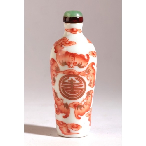 5 - A CHINESE PORCELAIN SNUFF BOTTLE

Daoguang seal mark and period, decorated in red enamel with a cent... 