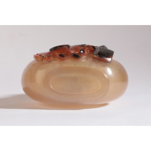 51 - A CHINESE AGATE SNUFF BOTTLE

19th century, carved to the front with a horse tethered to a post set ... 