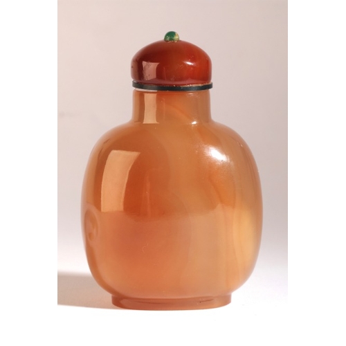 56 - A CHINESE AGATE SNUFF BOTTLE

18th/19th century, the honey coloured body of bulbous form with rams c... 